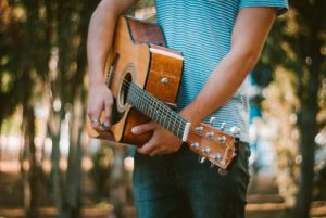 Person Holding Guitar.